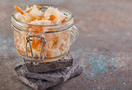Fermented vegetarian canned food concept. Sauerkraut in a glass jar. The concept of canned food.の写真素材