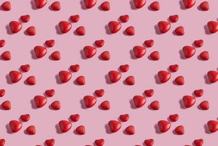 Valentines Day pattern with candy hearts on a pink background.の写真素材