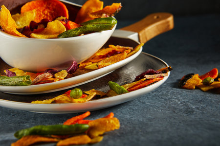 Dry fruit and Healthy vegetable chips, healthy vegan snack, a mixed heap: yellow sweet potato purple sweet potato carrot green radish green beans and shiitake mushrooms.の写真素材