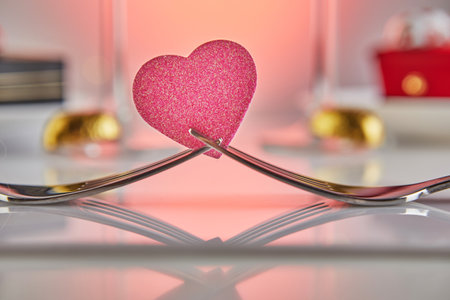 Valentines Day or romantic birthday dinner with candy hearts, champagne glasses and elegant table setting with reflection.の写真素材
