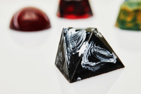 Chocolates in the form of precious stones - black marble on awhite background. Gift for St. Valentine.の写真素材