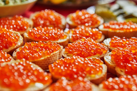 Baguette sandwiches with red caviar, butter on the festive table.