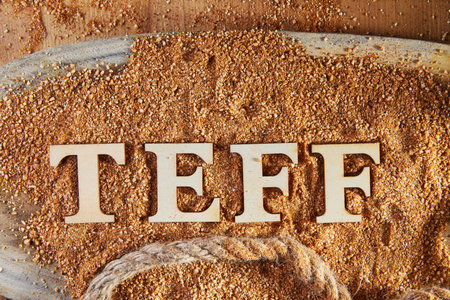 Teff, an alternative to ancient gluten-free grain with the name written in wooden letters. Teff has...