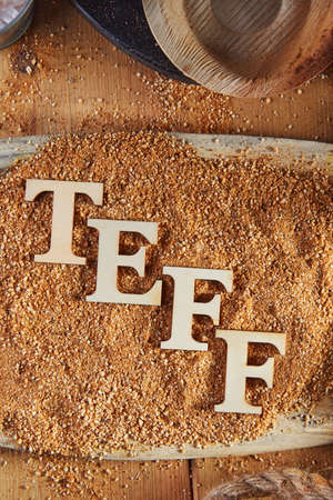 Teff, an alternative to ancient gluten-free grain with the name written in wooden letters. Teff has become a popular choice for healthy eating.の写真素材
