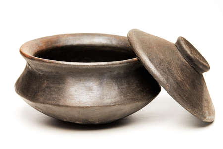 Clay pot with lid made of special black clay for cooking, isolated on a white background.の写真素材