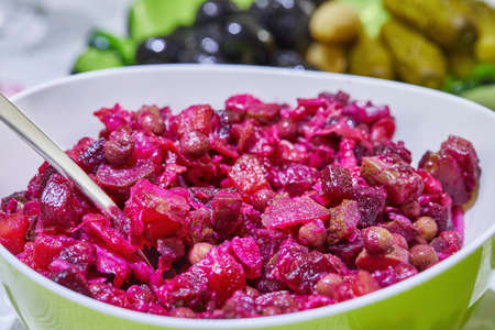 Vinaigrette salad in large bowl, served on festive table.の写真素材