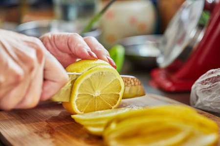Chef slices lemon to add to the lamb. Step by step recipe.の写真素材