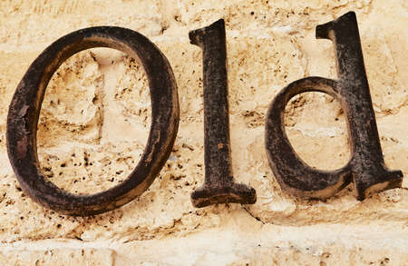 The word old in metal letters on stone background.の写真素材