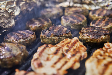 BBQ burgers, grilled chicken legs BBQ smoke party. Close-up.