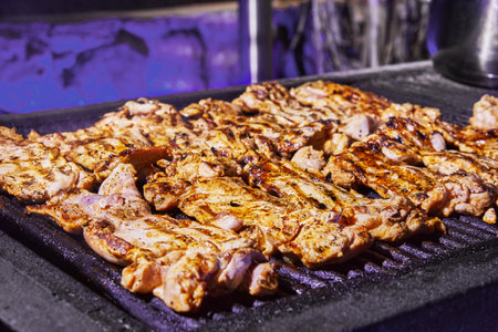 Grilled chicken legs with smoke from the grill coals. BBQ party.の写真素材