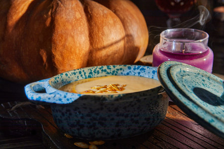 Halloween with candles with pumpkin and cream soup on spooky night - Halloween scene.の写真素材