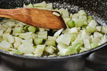 Fennel is fried in pan for recipe in the kitchen.の写真素材