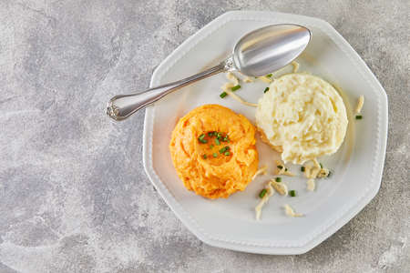 Serve with two-color mashed potatoes and sweet potatoes.の写真素材