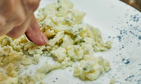 With a fork, the chef kneads mashed potatoes onplate.の写真素材