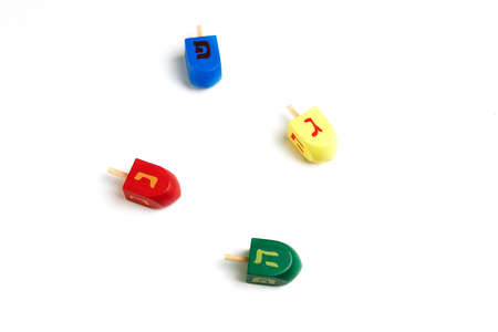 Happy Hanukkah and Hanukkah Sameach - traditional Jewish spinning tops with Hebrew letters on white background.の写真素材