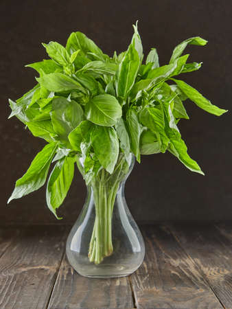 Bouquet of fresh basil in decanter, herbs to add to food.の写真素材