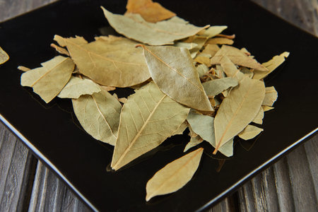 Bay leaf is seasoning for many dishes, on black plate