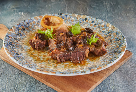 Ossobuco with spindle Beef, cognac and garlic black. French gourmet cuisine.