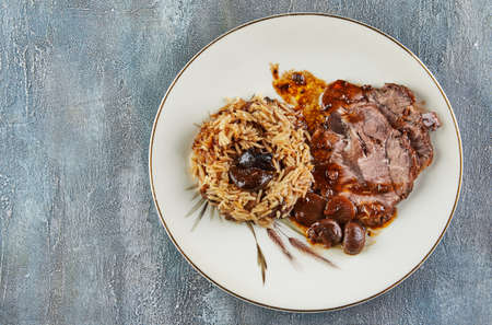 Beef in sauce with mushrooms and chestnuts and risotto. French gourmet cuisine. Flat layの写真素材