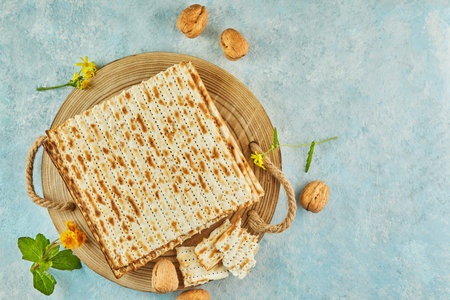 Pesach celebration concept - jewish Passover holiday. Matzah on wooden stand with nuts and...