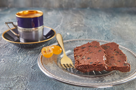 Orange chocolate Terrine on plate with cup of coffee.