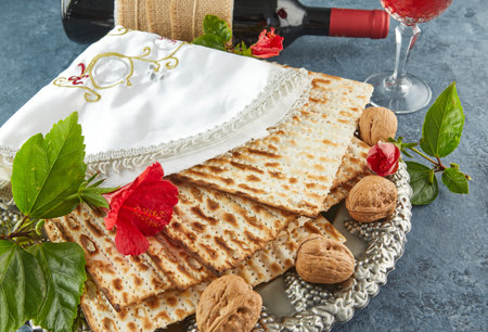 Pesach celebration concept - Jewish Passover holiday. Matzah on traditional Seder plate with bottle...
