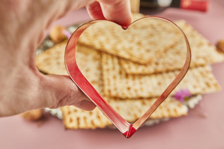 Pesah celebration concept - Jewish Passover holiday. Matzah and heart-shaped item.