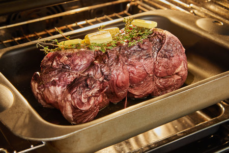 Beef with rosemary and butter is ready for baking in the ovenの写真素材