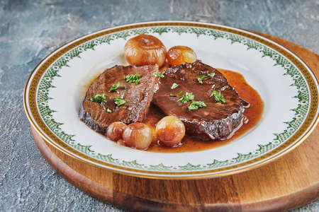 Roast beef with reduced wine sauce and shallotsの写真素材