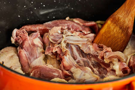 Fresh beef meat is fried with onions in pan on gas stove.の写真素材