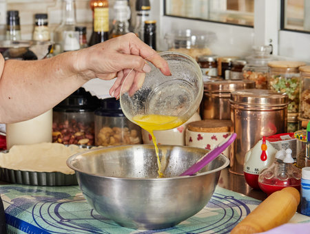 Chef pours the yolk into a pie-making bowl.