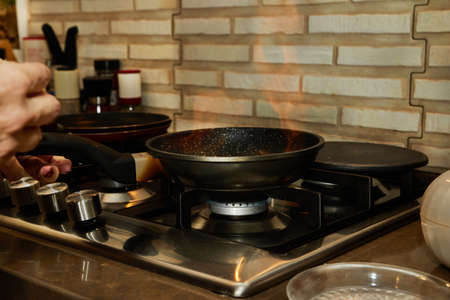 Chef pan-frying Crepe Suzette pancakes with cognac and citrus sauce. Flombe French gourmet cuisineの写真素材