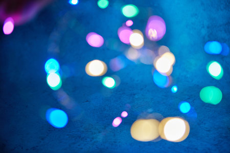 Background texture of blue background with multi-colored lights out of focus