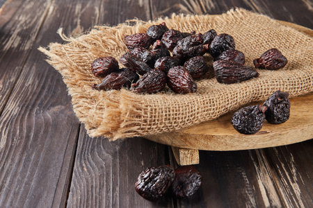 Dried mission figs on burlap and wooden backgroundの写真素材