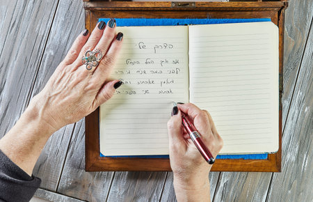 Rishon Lezion, Israel - February 2, 2022: Woman writes in her diary about life. flat lay.