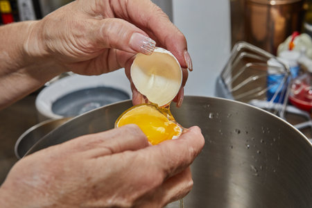 Chef separates the yolk from the protein to make the pieの写真素材