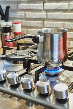 Cooking food in frying pan and pot on gas stove in the kitchen. Home cooking conceptの写真素材