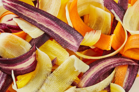 Slices of carrots of three colors, cut into strips in glass bowlの写真素材