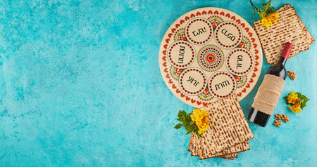 Pesach celebration concept - Jewish holiday Pesach. Background with yellow flowers with a glass of...
