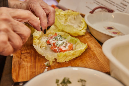 Chef makes Cabbage rolls with salmon, carrots and sauce in the kitchen. french recipe.の写真素材