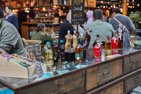 Food shops, restaurants, cafes and grocery stores at Sarona Organic Market, modern food market in...