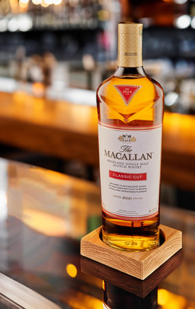 Luxurious Macallan limited edition whiskey sits on the bar, the bar and bottles out of focus.のeditorial素材