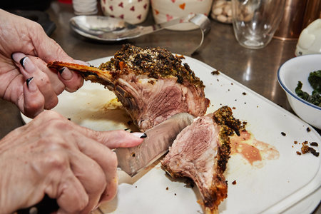 Chef cuts Lamb ribs with garlic and mustard sauce, after baking in the oven.の写真素材