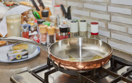Sunflower oil in copper pan on gas stove.の写真素材
