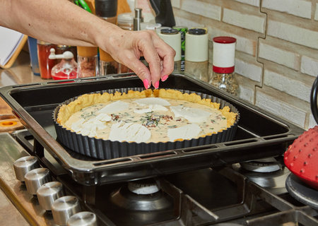 Chef prepares Cheese Pie before baking in the electric oven.の写真素材