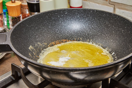 Caramelized syrup in frying pan on gas stove fireの写真素材