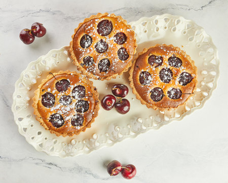 French Flair, Cherry Clafoutis Presented on White Marble. Mouthwatering Temptation: Clafoutis and Cherries on Marbleの写真素材
