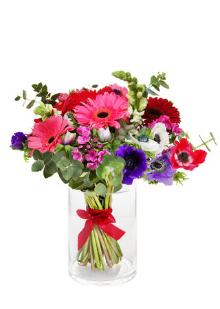 Beautiful huge bouquet of red and pink gerberas in vase on white background.の写真素材