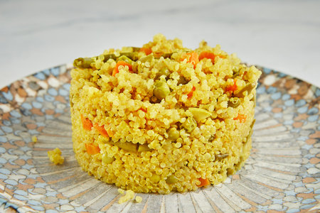 Quinoa pilaf with carrots, zucchini and green peas. Close up.の写真素材