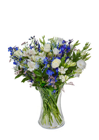 Beautiful huge bouquet of white roses with lilies and blue flowers in vase isolated on white background.の写真素材